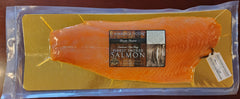 Packaged salmon fillet on a yellow cutting board with a label on a wooden surface